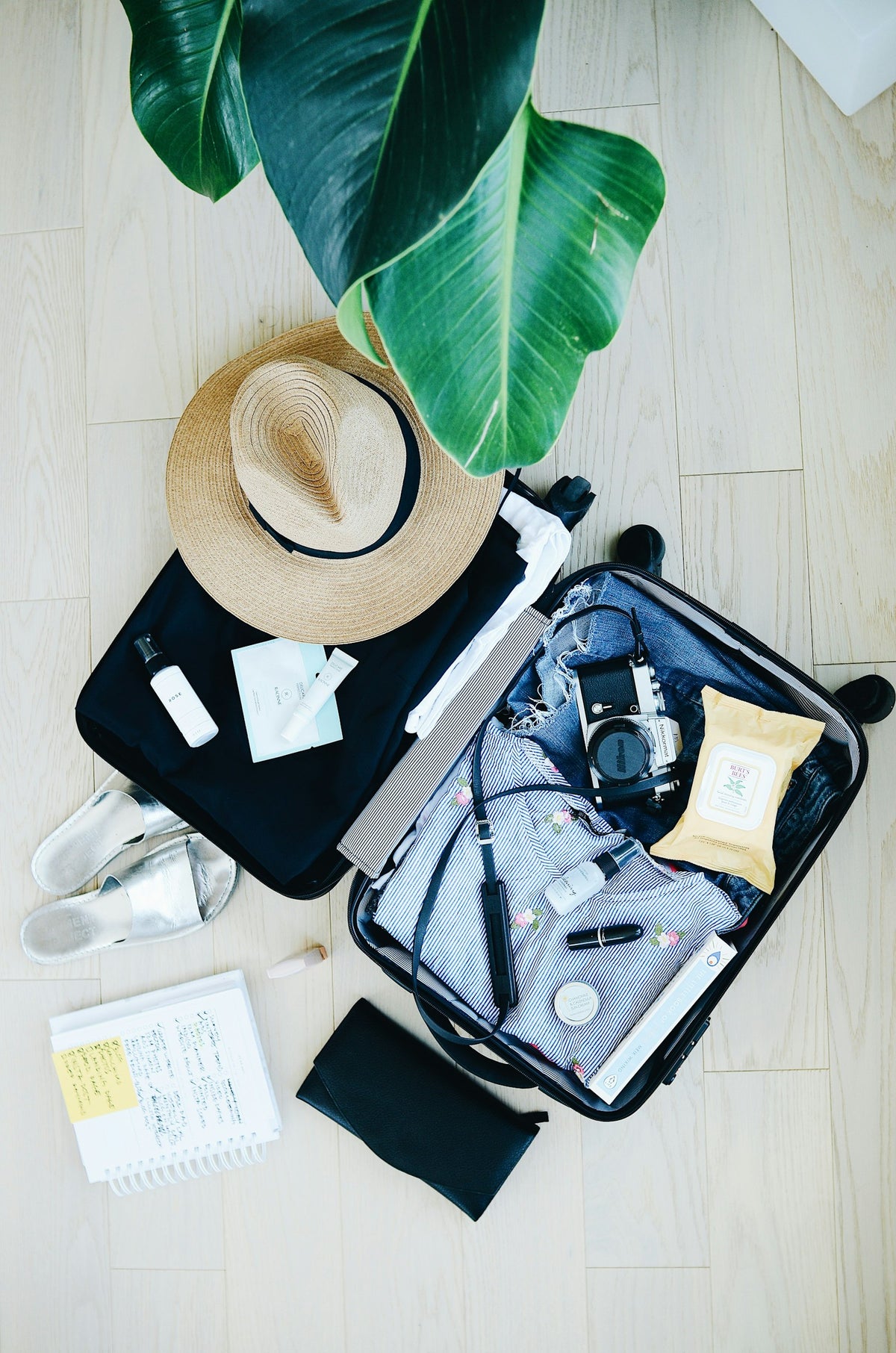Open suitcase with travel essentials