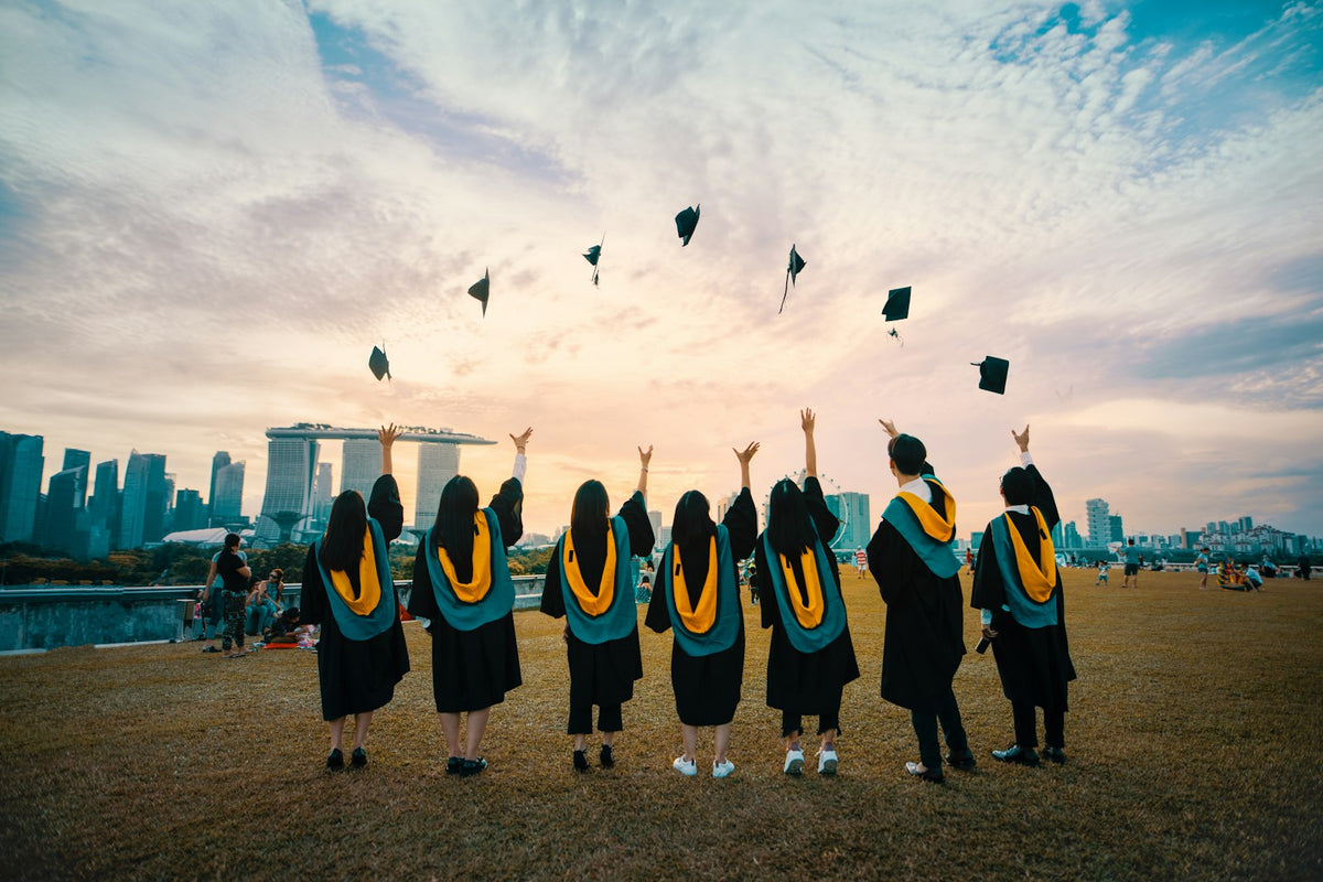 Graduates throwing caps in the air