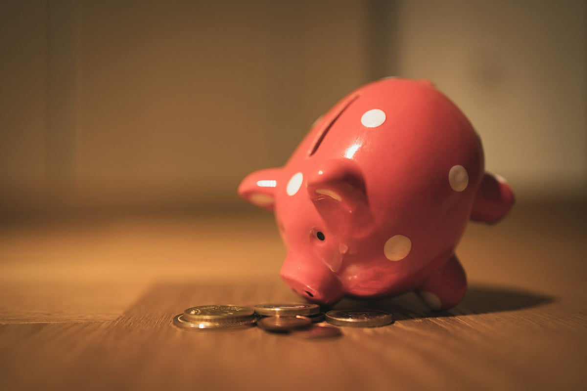 Pink piggy bank on a wooden table