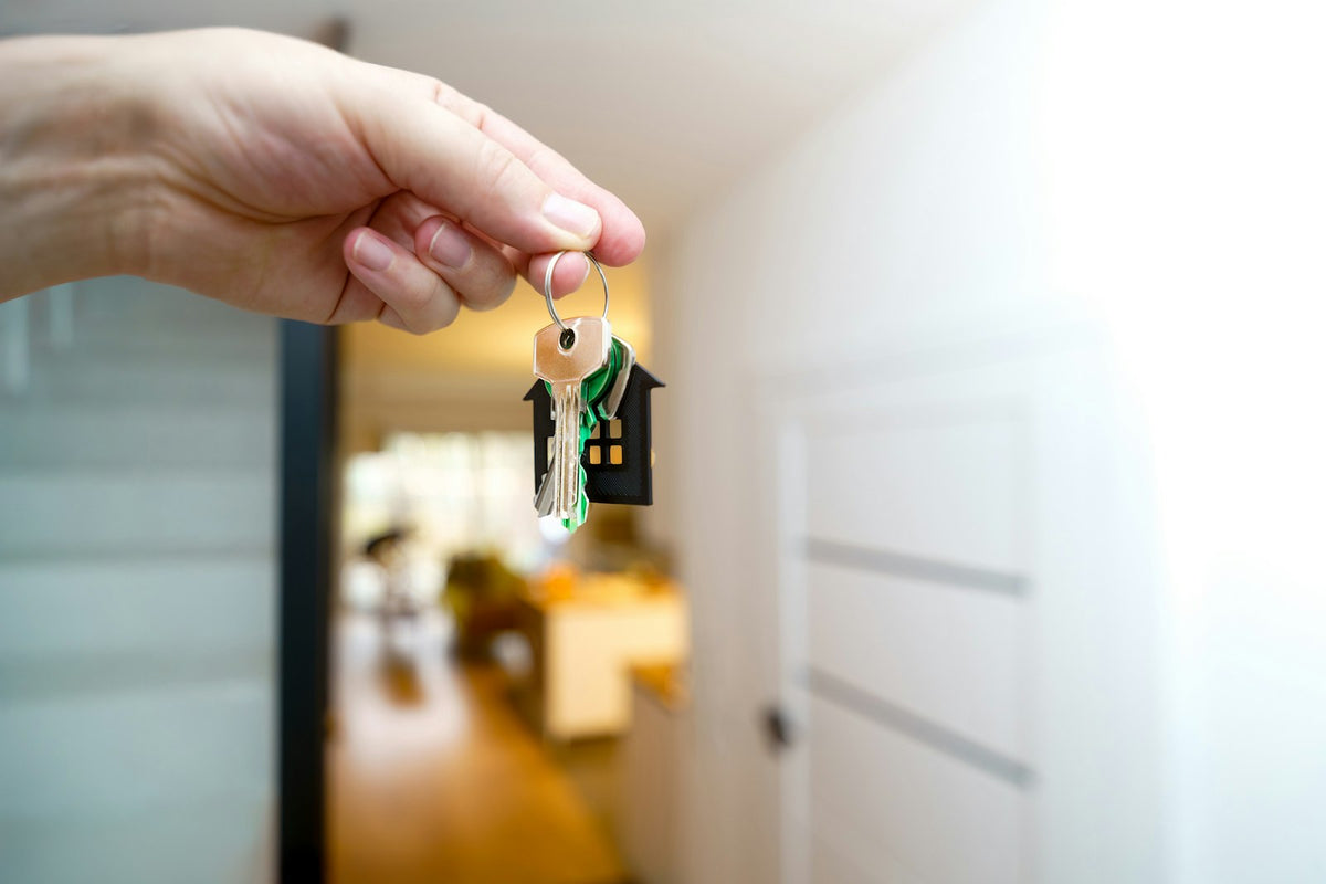 Holding house keys at a front door